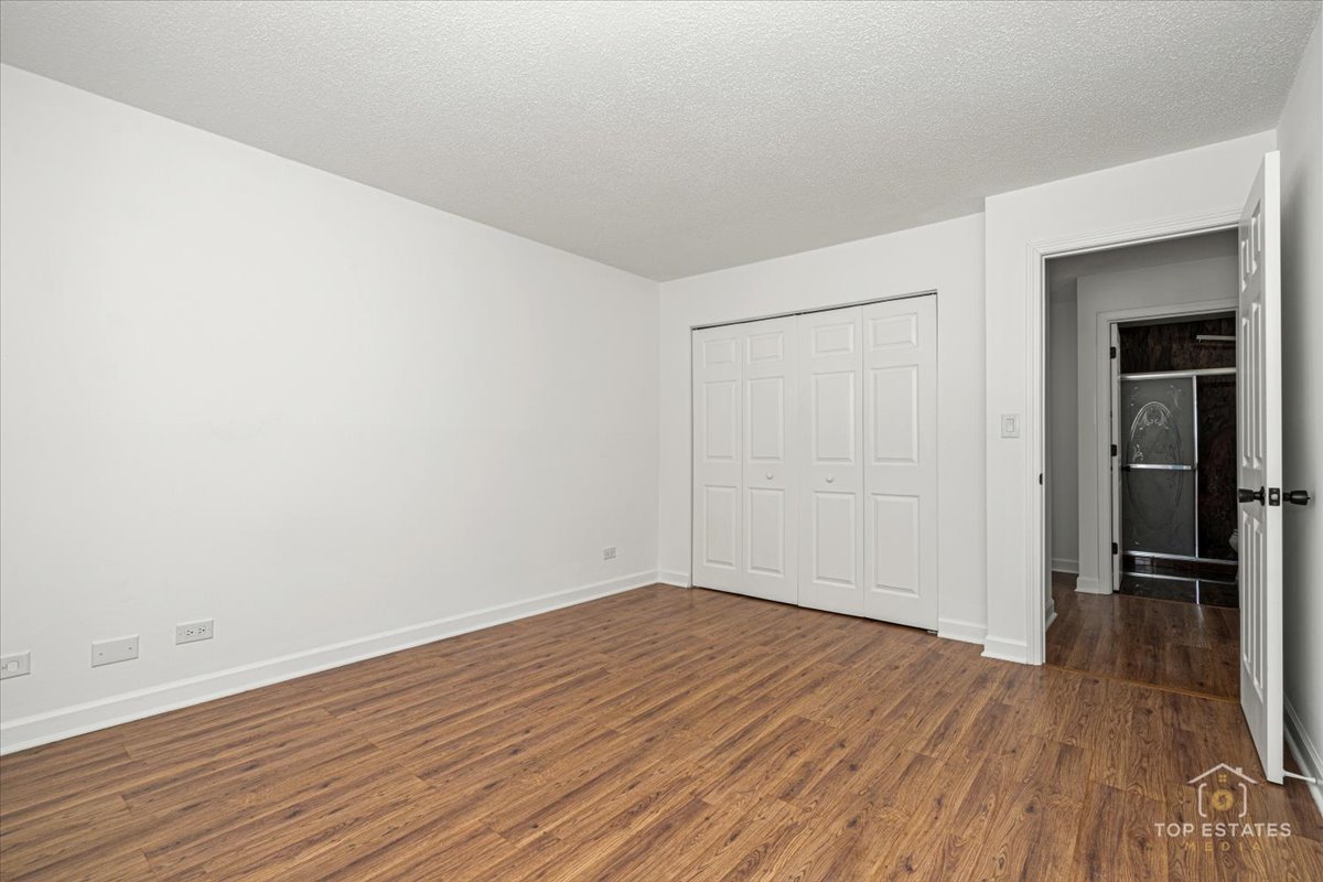 1107 South Old Wilke Road, Unit 208 Rolling Meadows, IL 60005 - Photo 30 of 43 an empty room with wooden floor and closet