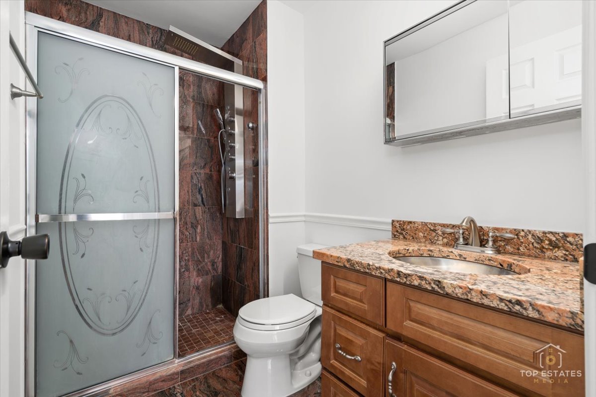 1107 South Old Wilke Road, Unit 208 Rolling Meadows, IL 60005 - Photo 32 of 43 a bathroom with a granite countertop toilet sink and mirror