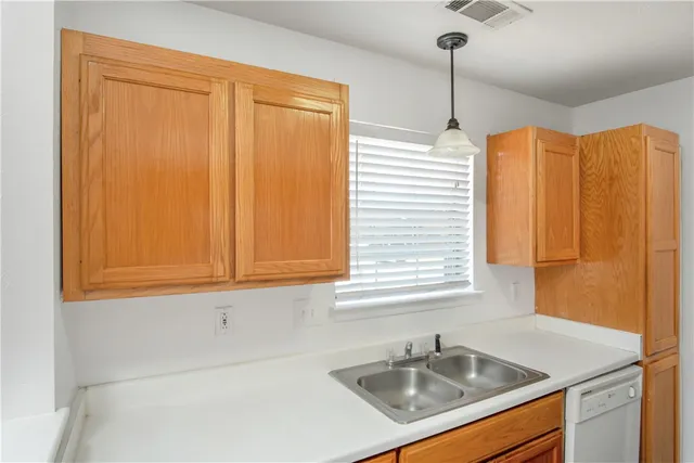 a kitchen with a sink cabinets and window