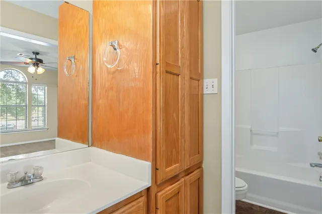 a view of a livingroom with a ceiling fan and window