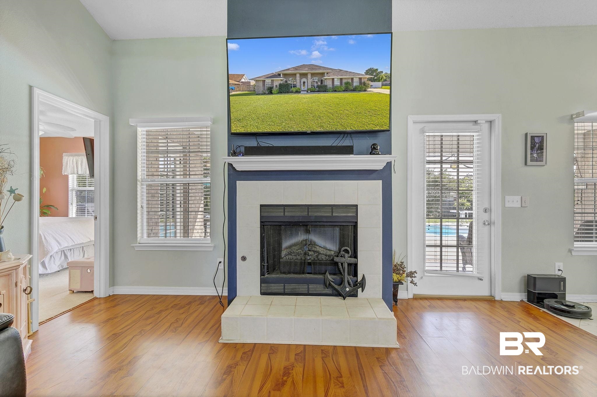 16358 Tempest Drive Foley, AL 36535 - Photo 10 of 46 Unfurnished living room featuring baseboards, wood finished floors, and a fireplace