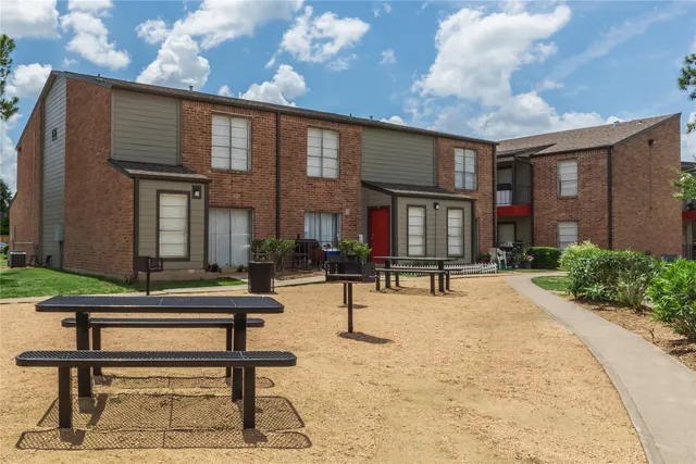 a view of pool with chairs and tables