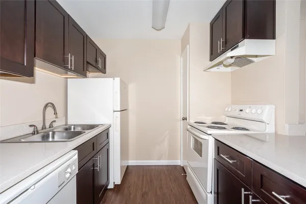 a kitchen with a sink stove and refrigerator
