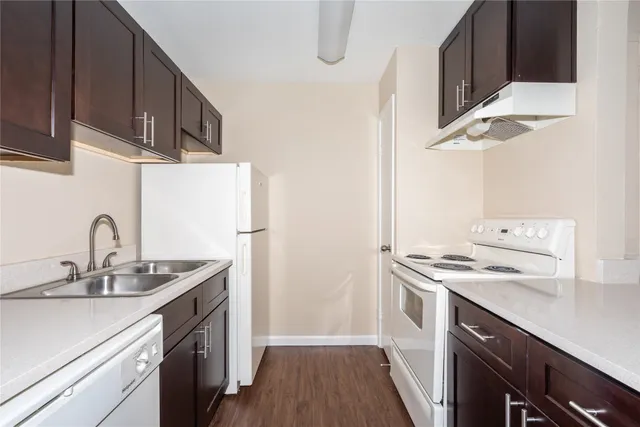 a kitchen with a sink stove and refrigerator