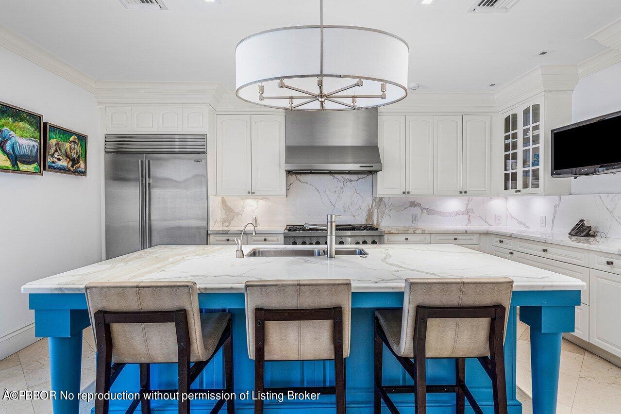 168 Kings Road Palm Beach, FL 33480 - Photo 11 of 30 a kitchen with stainless steel appliances a stove a sink and a refrigerator