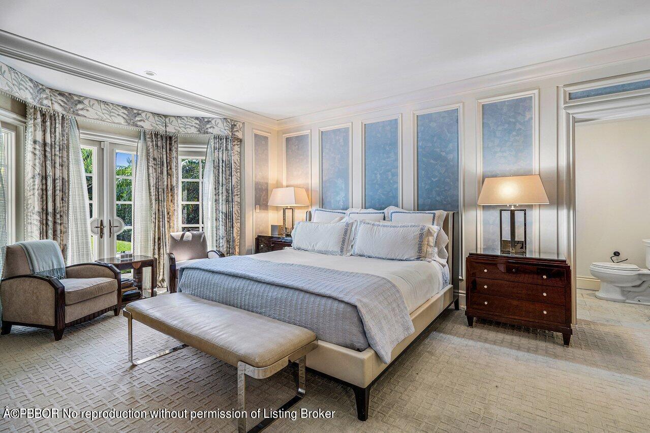 168 Kings Road Palm Beach, FL 33480 - Photo 13 of 30 a spacious bedroom with a bed a lamp and a large window
