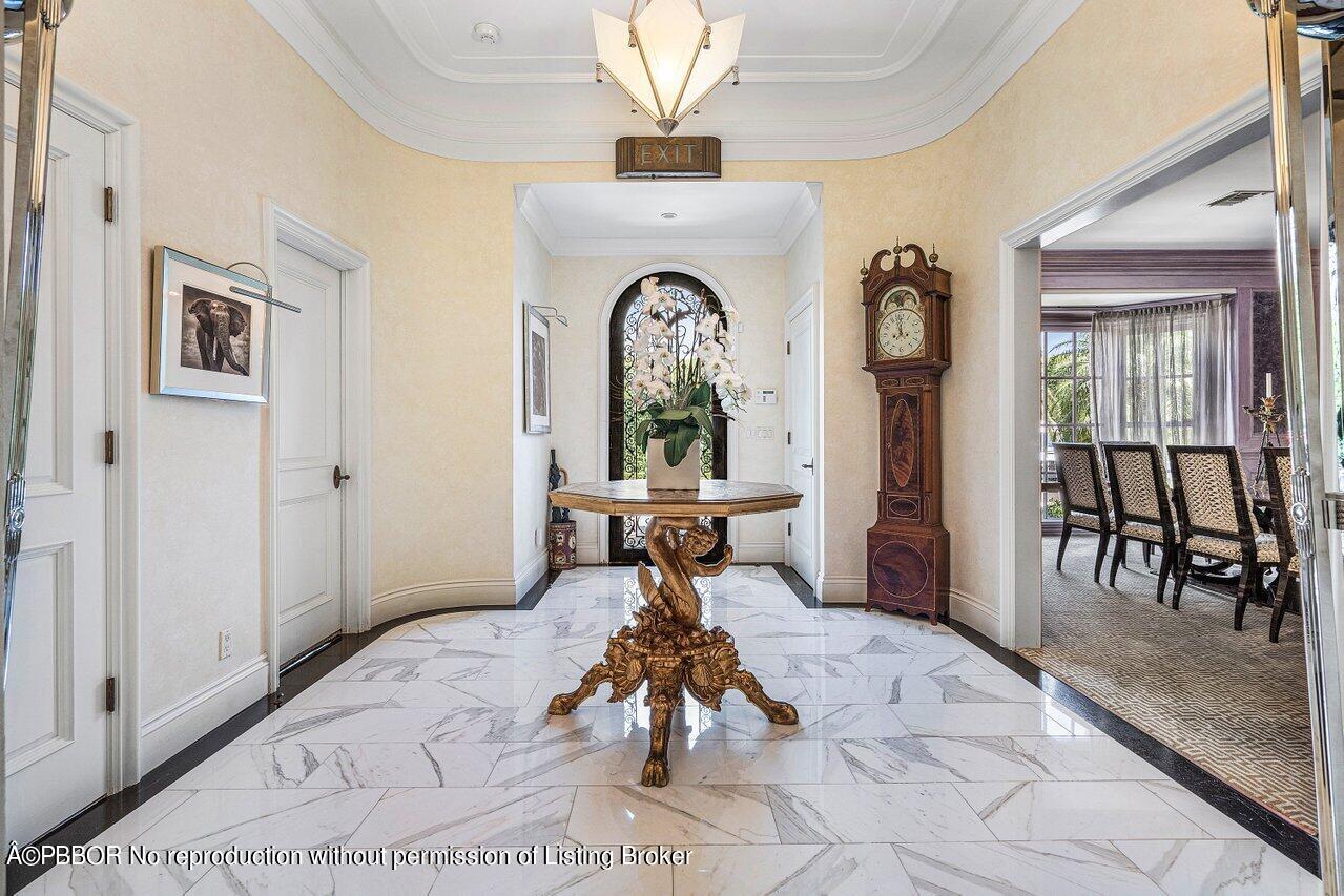 168 Kings Road Palm Beach, FL 33480 - Photo 3 of 30 a bedroom with a bed and a chandelier