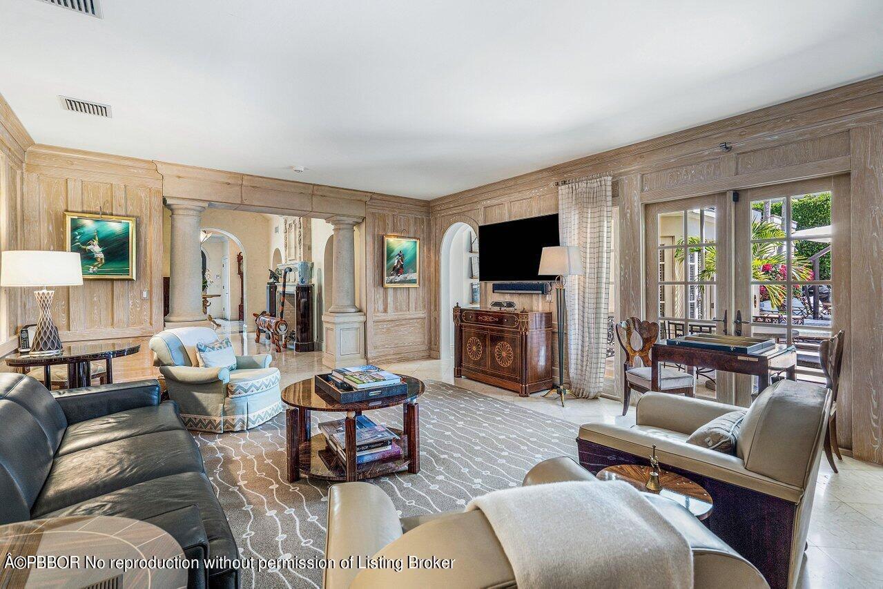 168 Kings Road Palm Beach, FL 33480 - Photo 6 of 30 a living room with furniture a flat screen tv and a fireplace