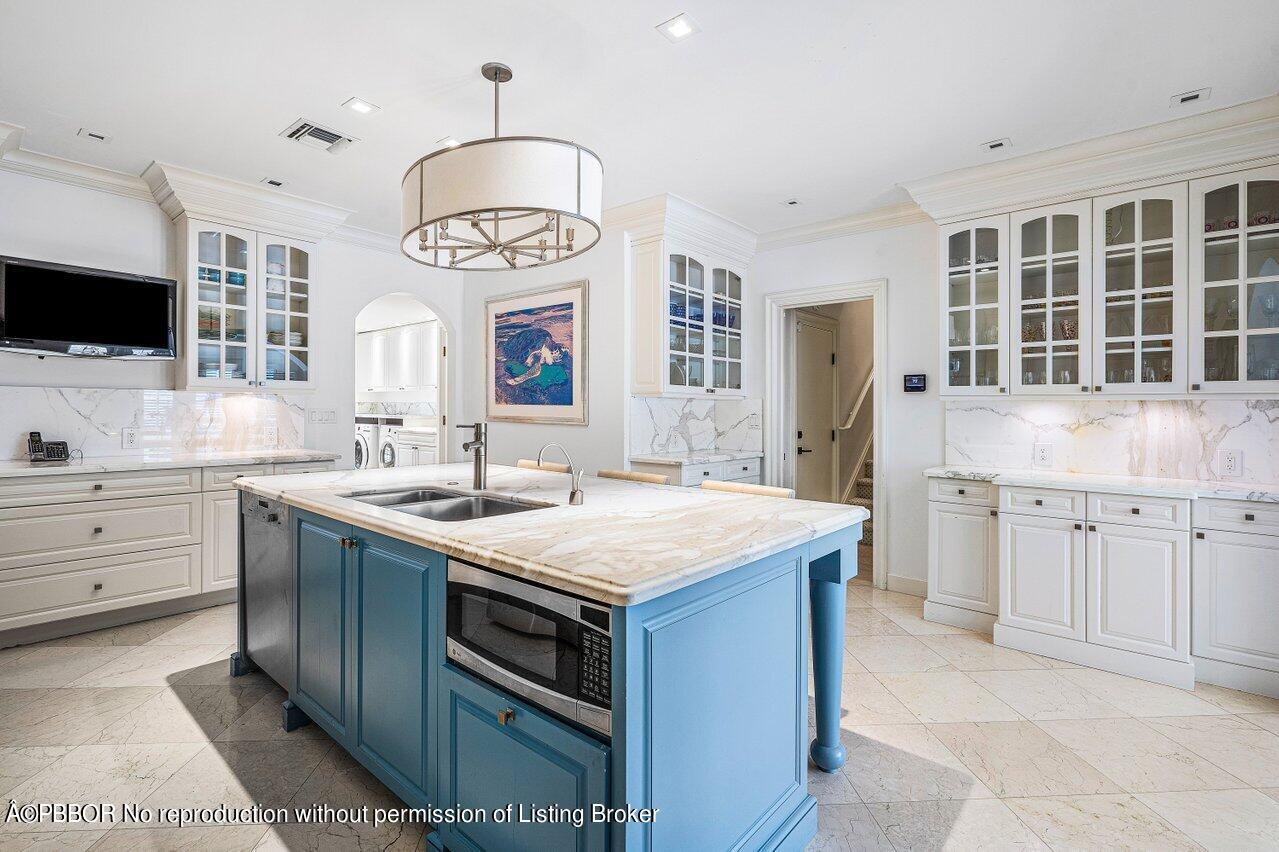 168 Kings Road Palm Beach, FL 33480 - Photo 9 of 30 a kitchen with a sink stove and cabinets