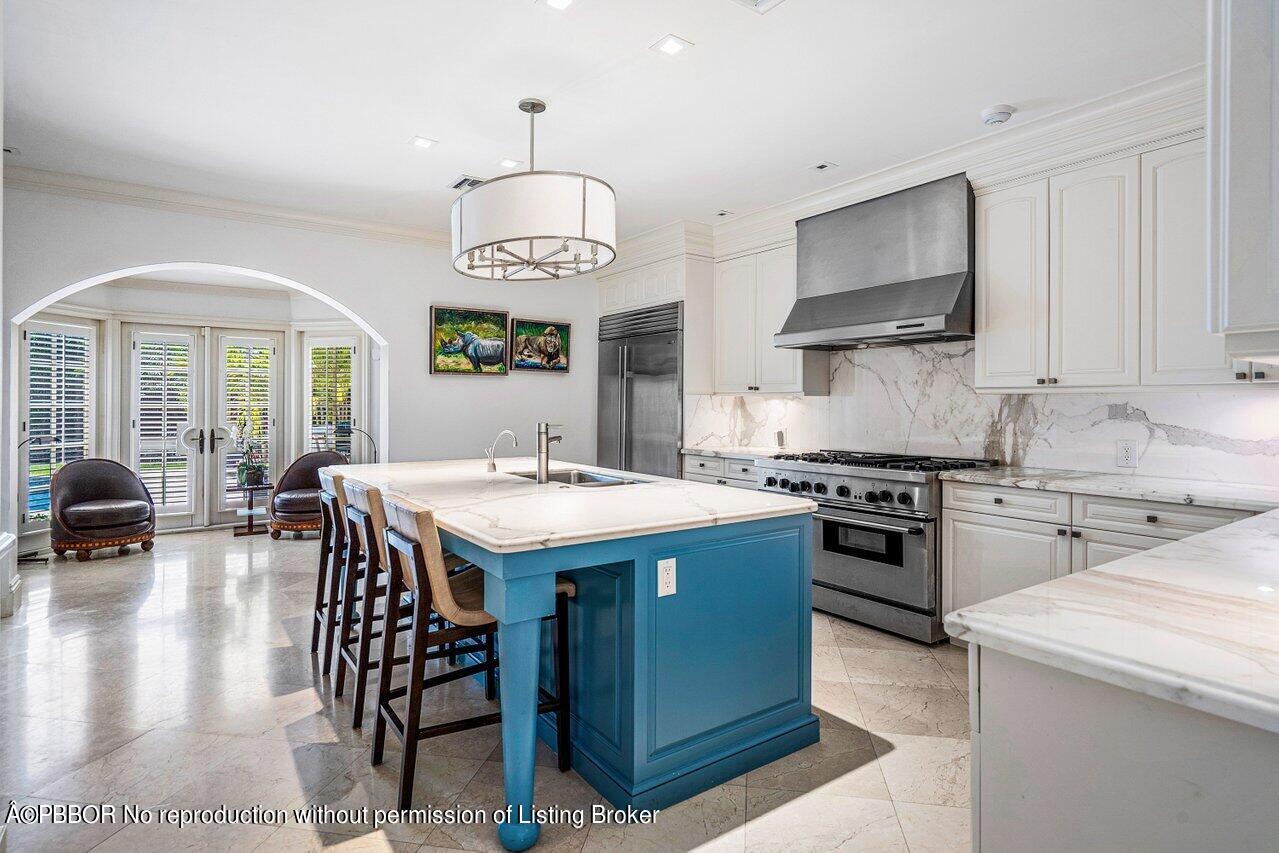 168 Kings Road Palm Beach, FL 33480 - Photo 10 of 30 a kitchen with stainless steel appliances granite countertop a sink a stove and a refrigerator