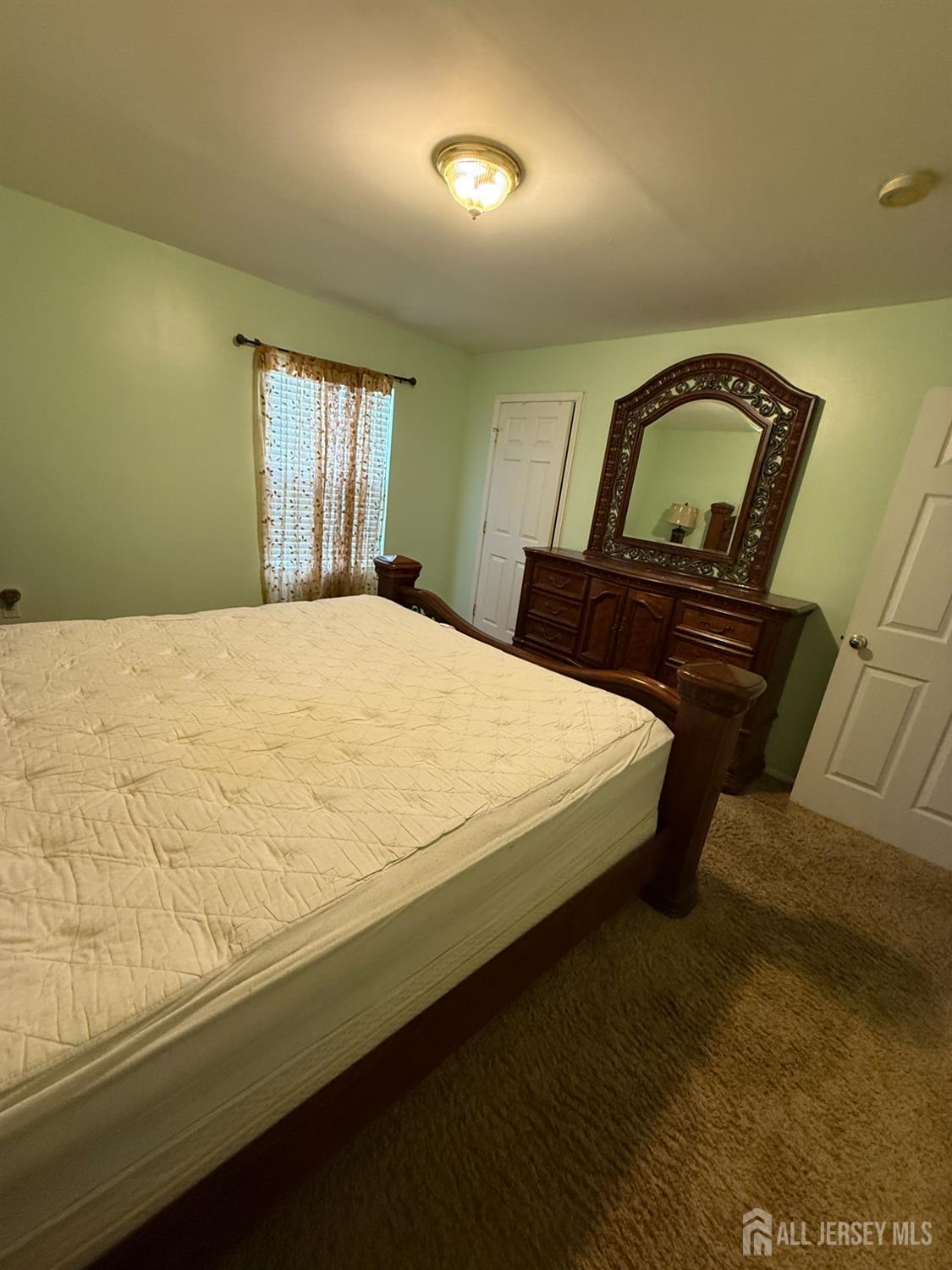 31 Beverly Street, Unit 2ND F Carteret, NJ 07008 - Photo 10 of 20 a bedroom with a bed and window