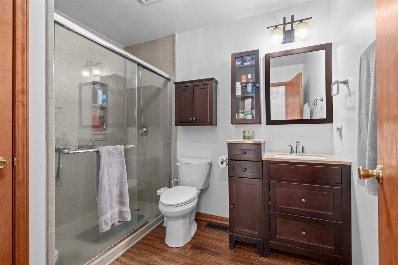 4461 Highway 23 Leland, IL 60531 - Photo 14 of 28 a bathroom with a toilet sink a mirror and shower