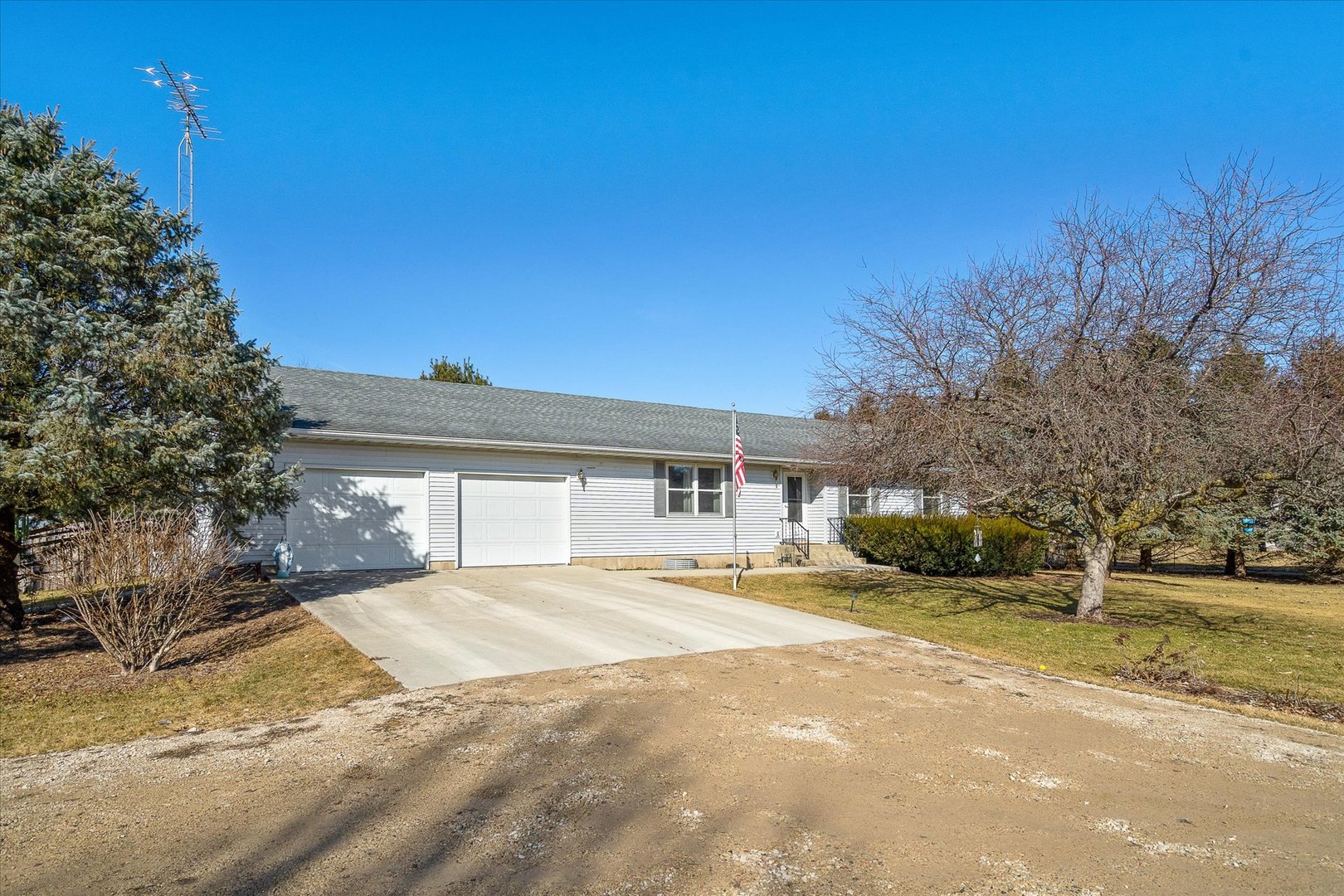 4461 Highway 23 Leland, IL 60531 - Photo 4 of 28 a front view of a house with a yard and garage
