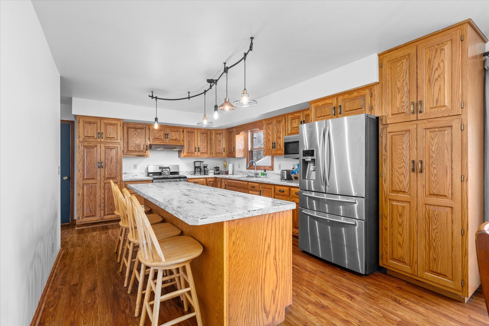 4461 Highway 23 Leland, IL 60531 - Photo 8 of 28 a kitchen with stainless steel appliances granite countertop a refrigerator a sink dishwasher and wooden cabinets with wooden floor