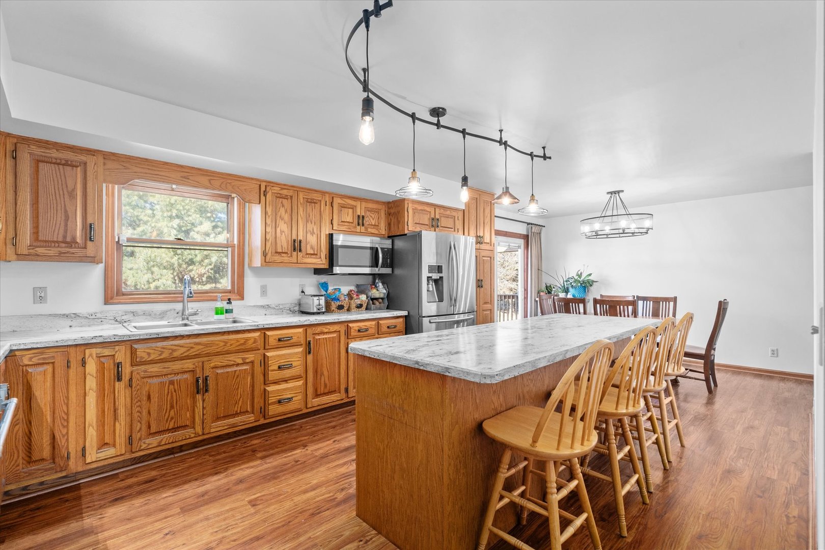 4461 Highway 23 Leland, IL 60531 - Photo 10 of 28 a kitchen with stainless steel appliances granite countertop a kitchen island a stove a table and chairs in it