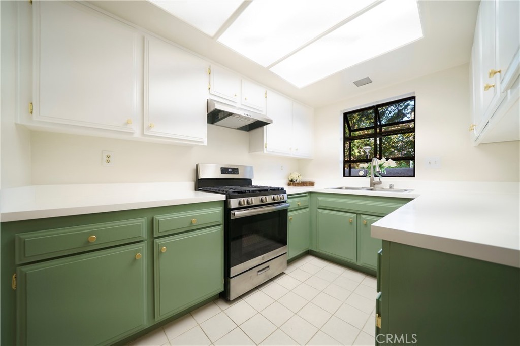 10663 Bell Street Stanton, CA 90680 - Photo 12 of 38 a kitchen with a sink cabinets and a window