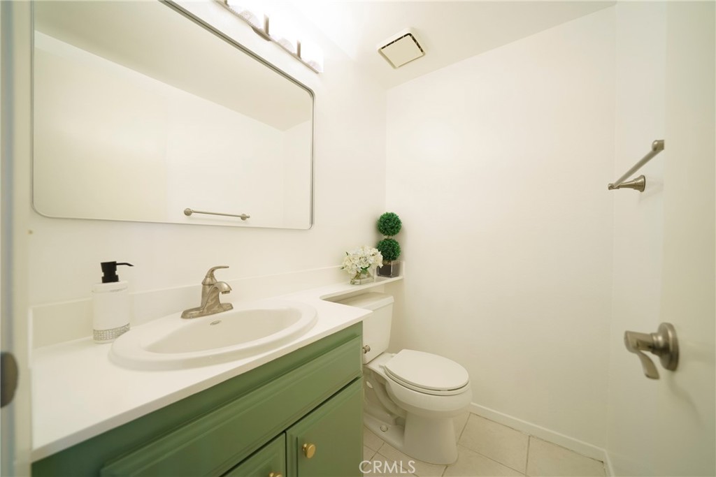 10663 Bell Street Stanton, CA 90680 - Photo 14 of 38 a bathroom with a sink a toilet and mirror