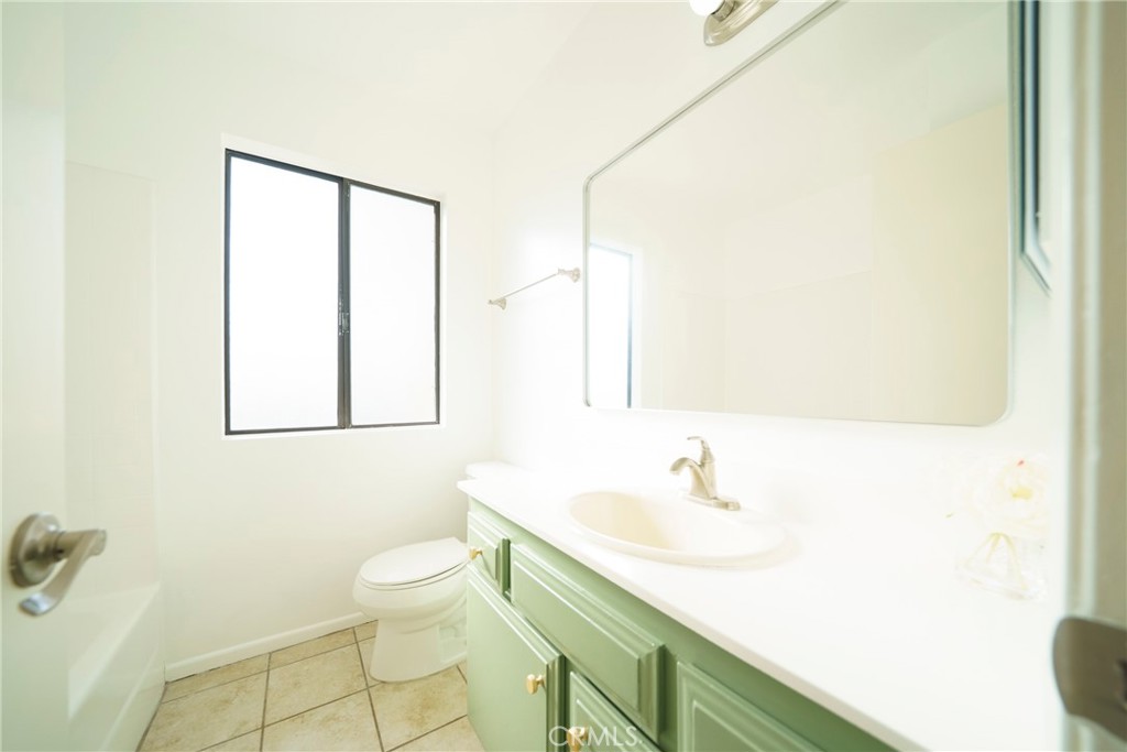 10663 Bell Street Stanton, CA 90680 - Photo 20 of 38 a bathroom with a sink and a mirror