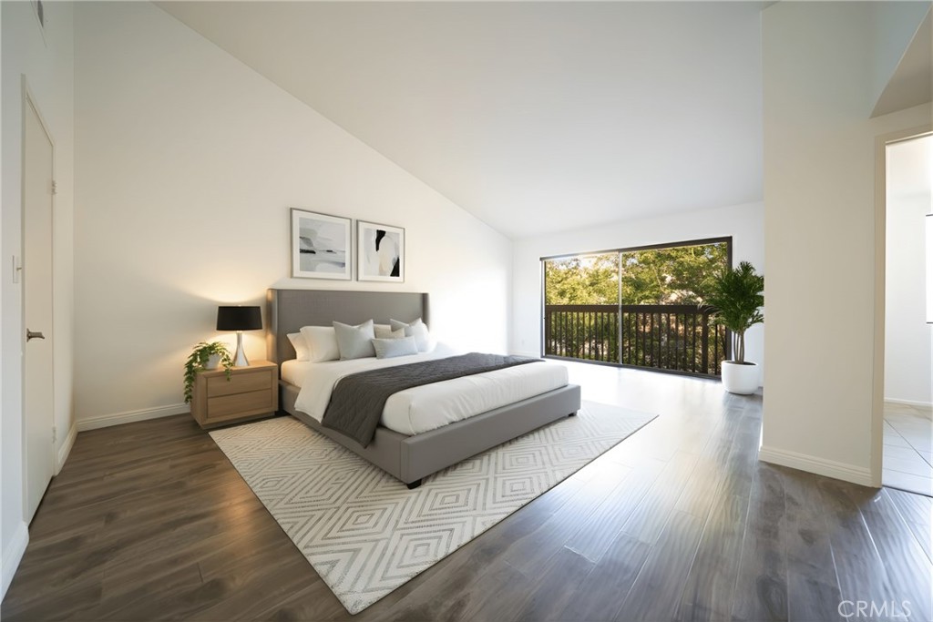 10663 Bell Street Stanton, CA 90680 - Photo 21 of 38 a spacious bedroom with a bed and a large window