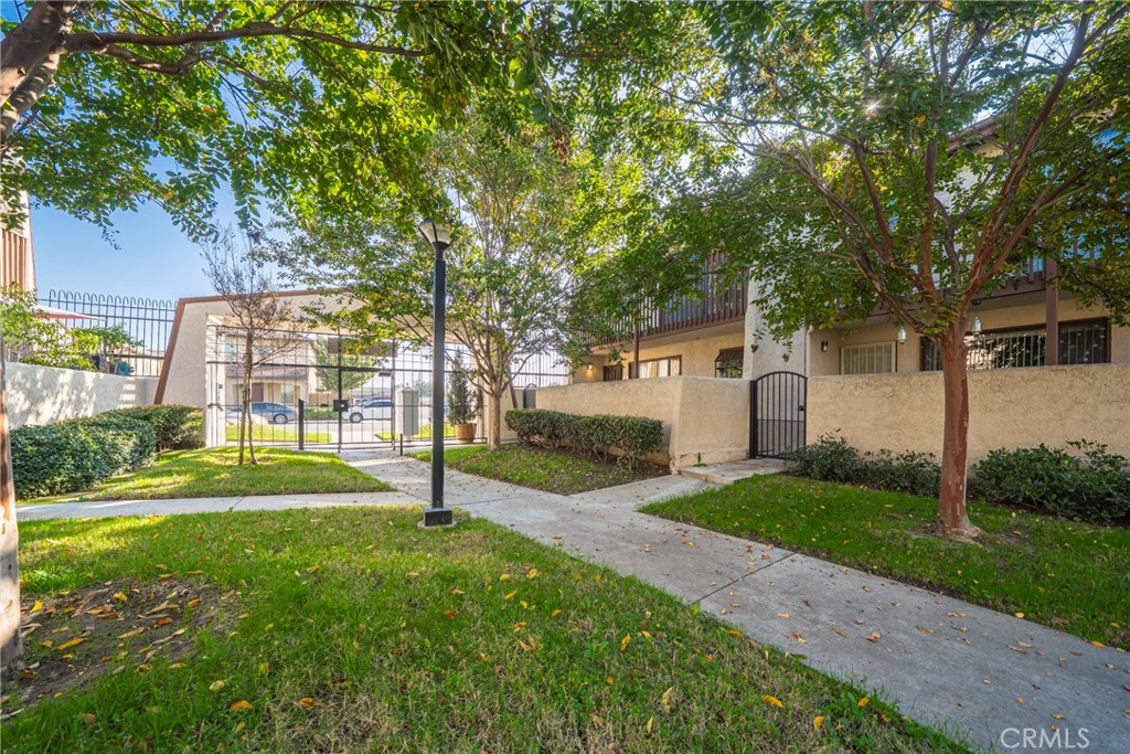 10663 Bell Street Stanton, CA 90680 - Photo 3 of 38 a view of a house with a yard and a large tree
