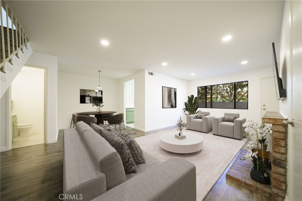10663 Bell Street Stanton, CA 90680 - Photo 6 of 38 a living room with furniture and a flat screen tv