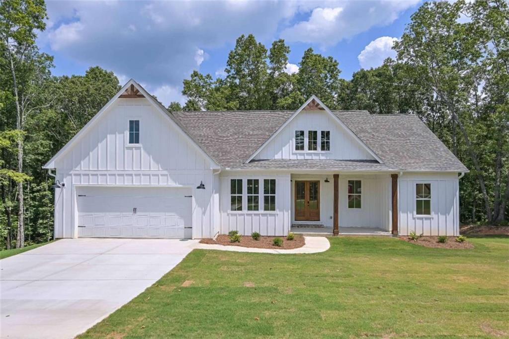 a front view of house with yard and green space