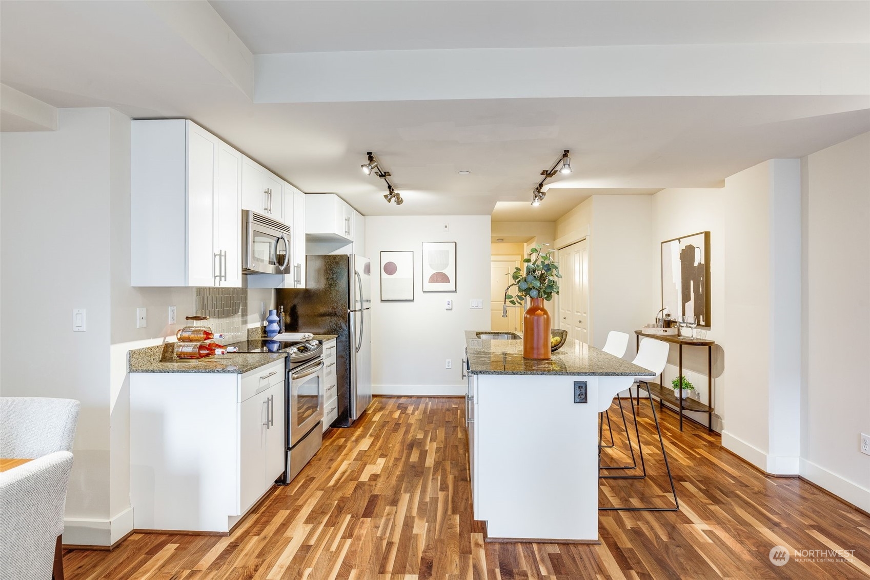 699 John Street, Unit 209 Seattle, WA 98109 - Photo 12 of 28 a view of a kitchen with dining table and chairs
