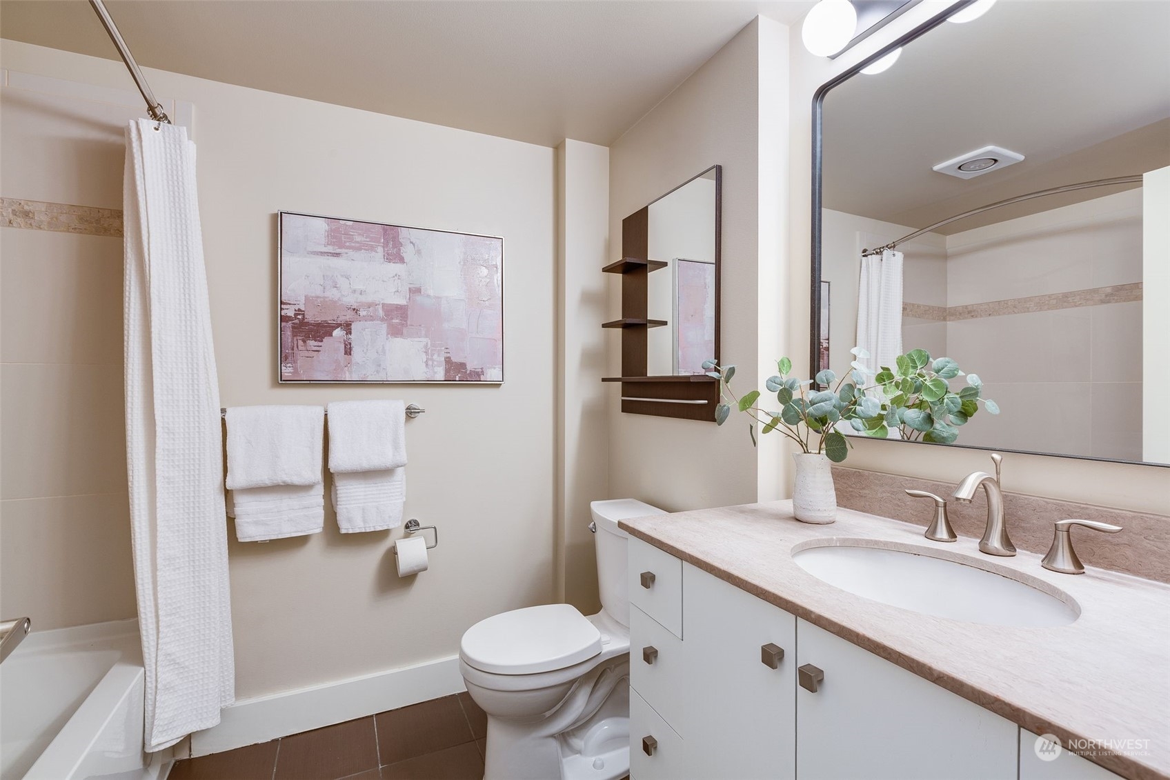 699 John Street, Unit 209 Seattle, WA 98109 - Photo 18 of 28 a bathroom with a granite countertop sink mirror vanity and toilet