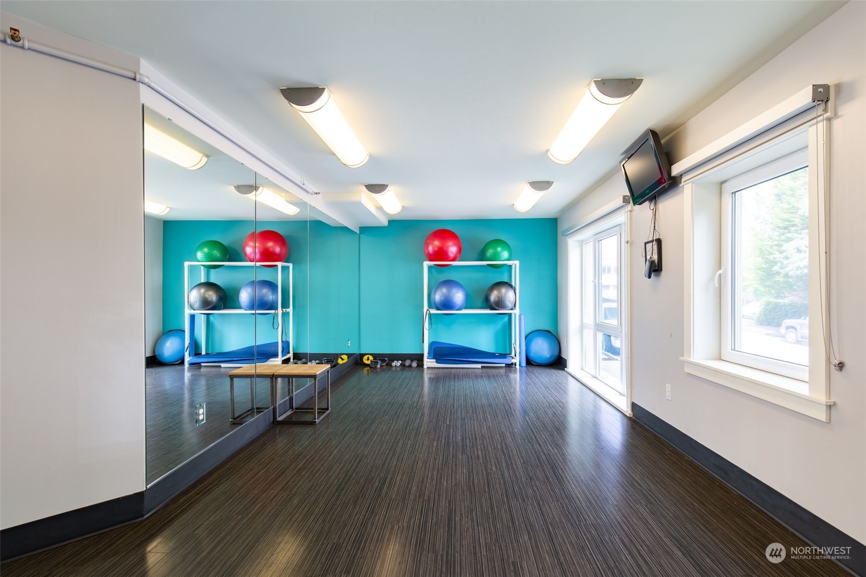 699 John Street, Unit 209 Seattle, WA 98109 - Photo 27 of 28 a living room with furniture and a wooden floor