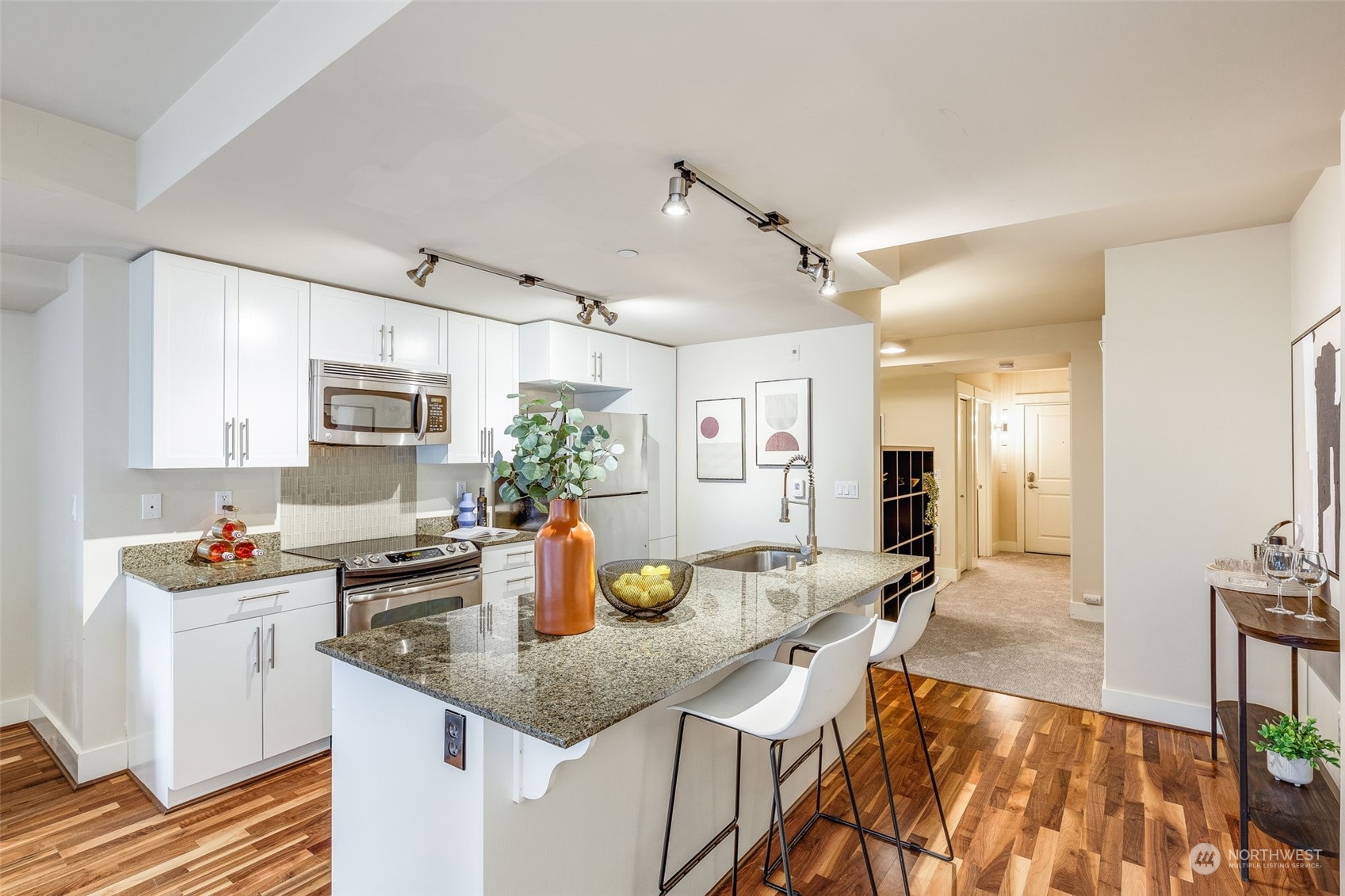 699 John Street, Unit 209 Seattle, WA 98109 - Photo 3 of 28 a kitchen with a counter top space a sink and cabinets