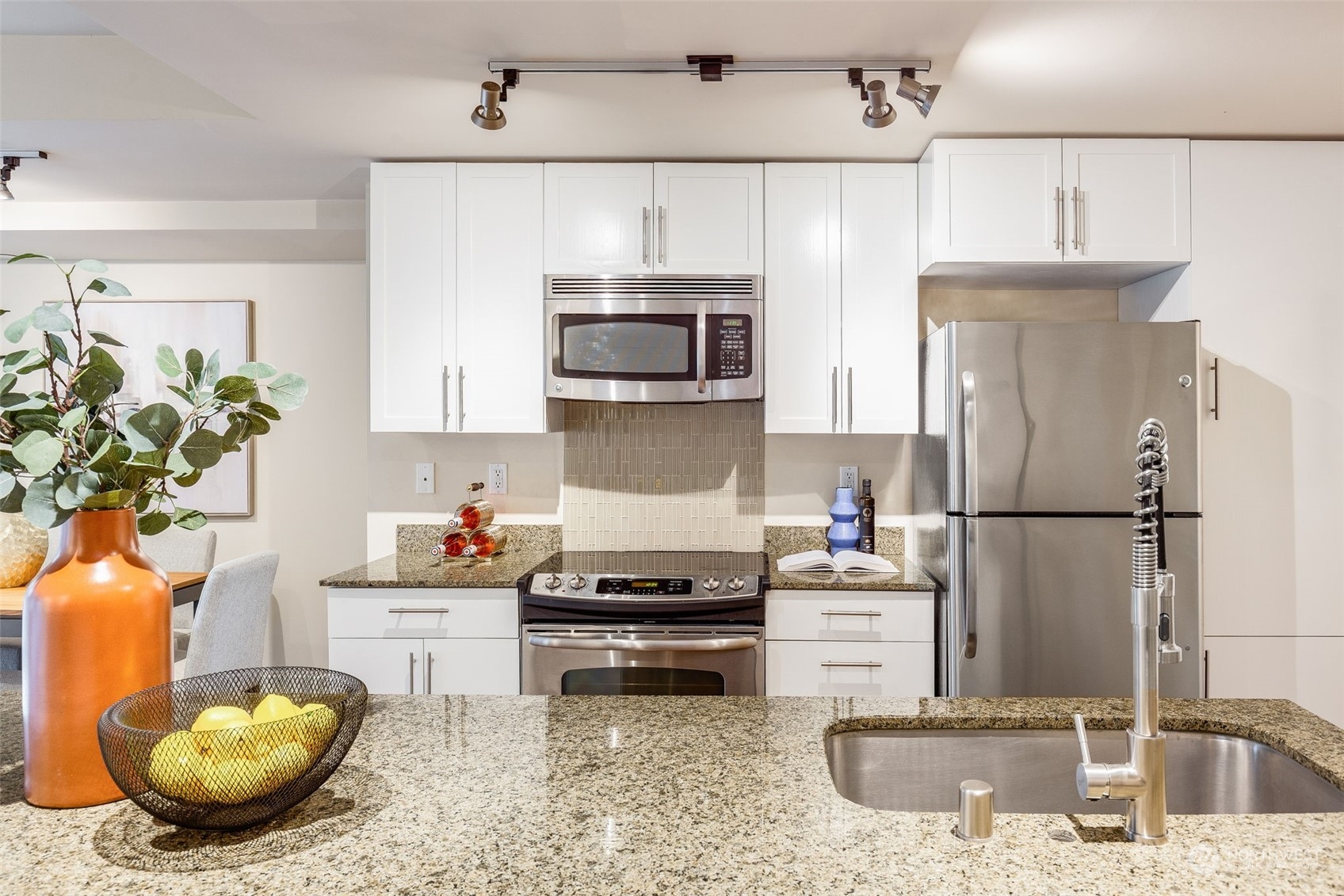 699 John Street, Unit 209 Seattle, WA 98109 - Photo 4 of 28 a kitchen with a sink and a stove