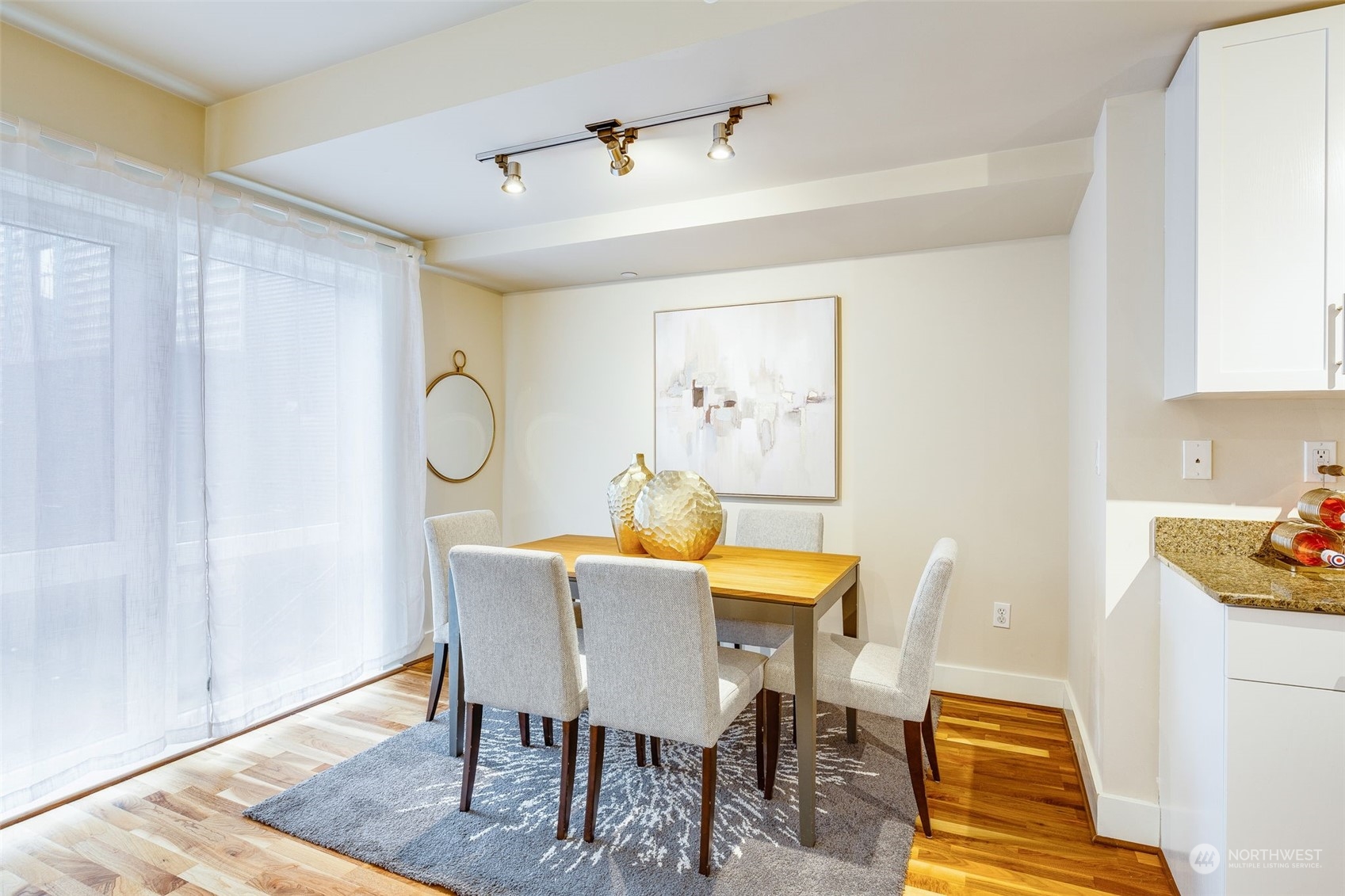 699 John Street, Unit 209 Seattle, WA 98109 - Photo 9 of 28 a dining room with furniture and wooden floor