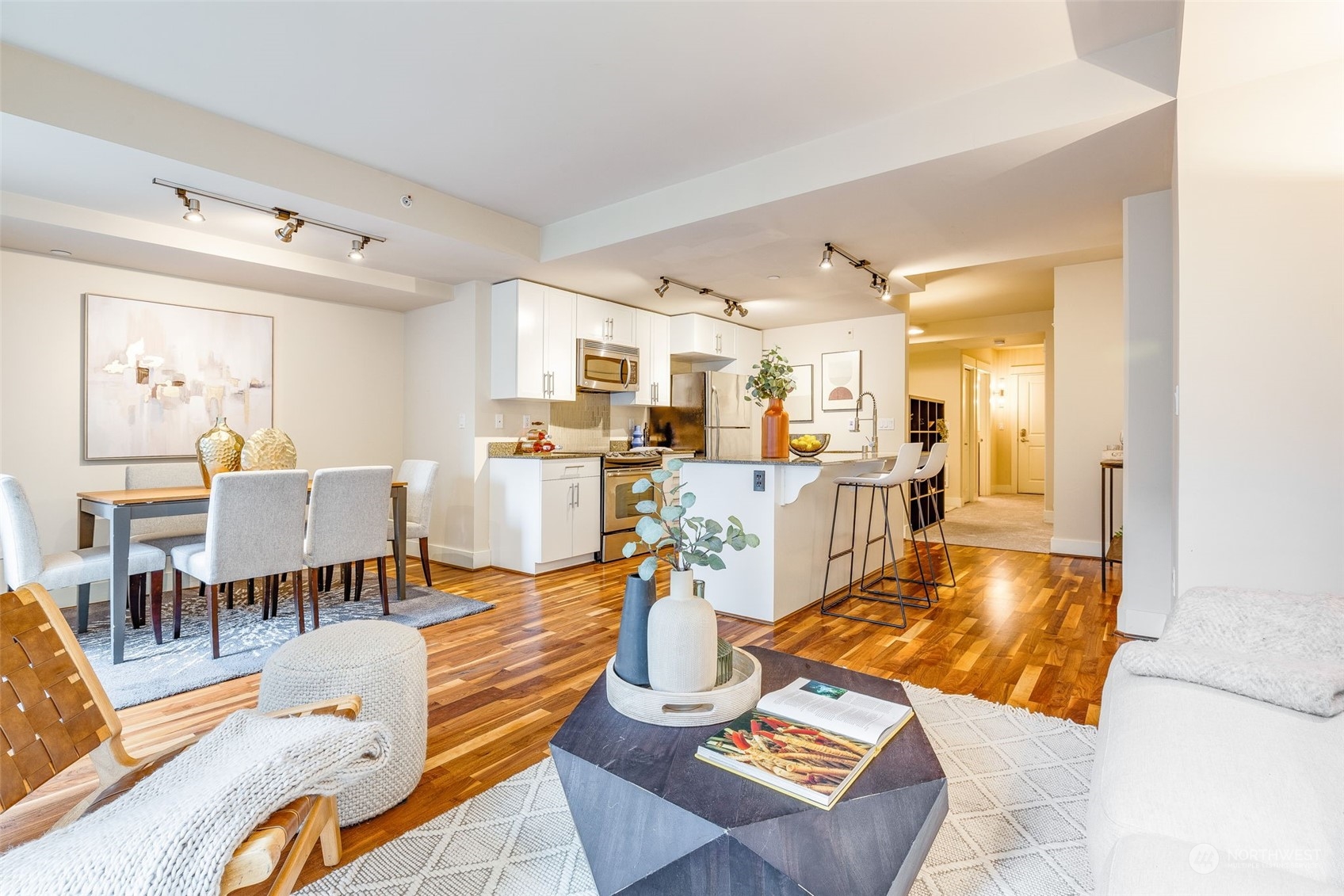 699 John Street, Unit 209 Seattle, WA 98109 - Photo 10 of 28 a living room with lots of furniture and kitchen view