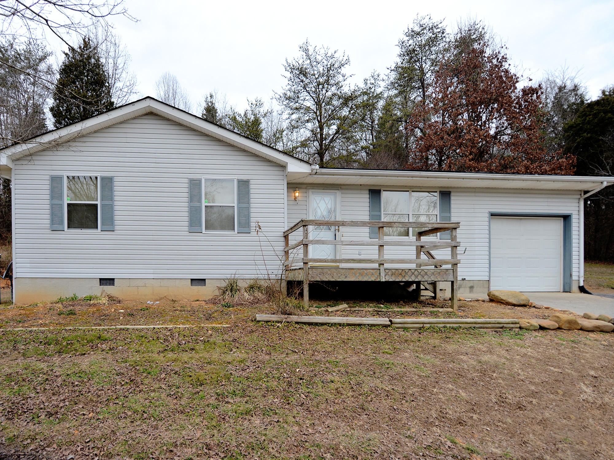 6762 Ross Road Philadelphia, TN 37846 - Photo 1 of 14 a backyard of a house with yard and retail shops