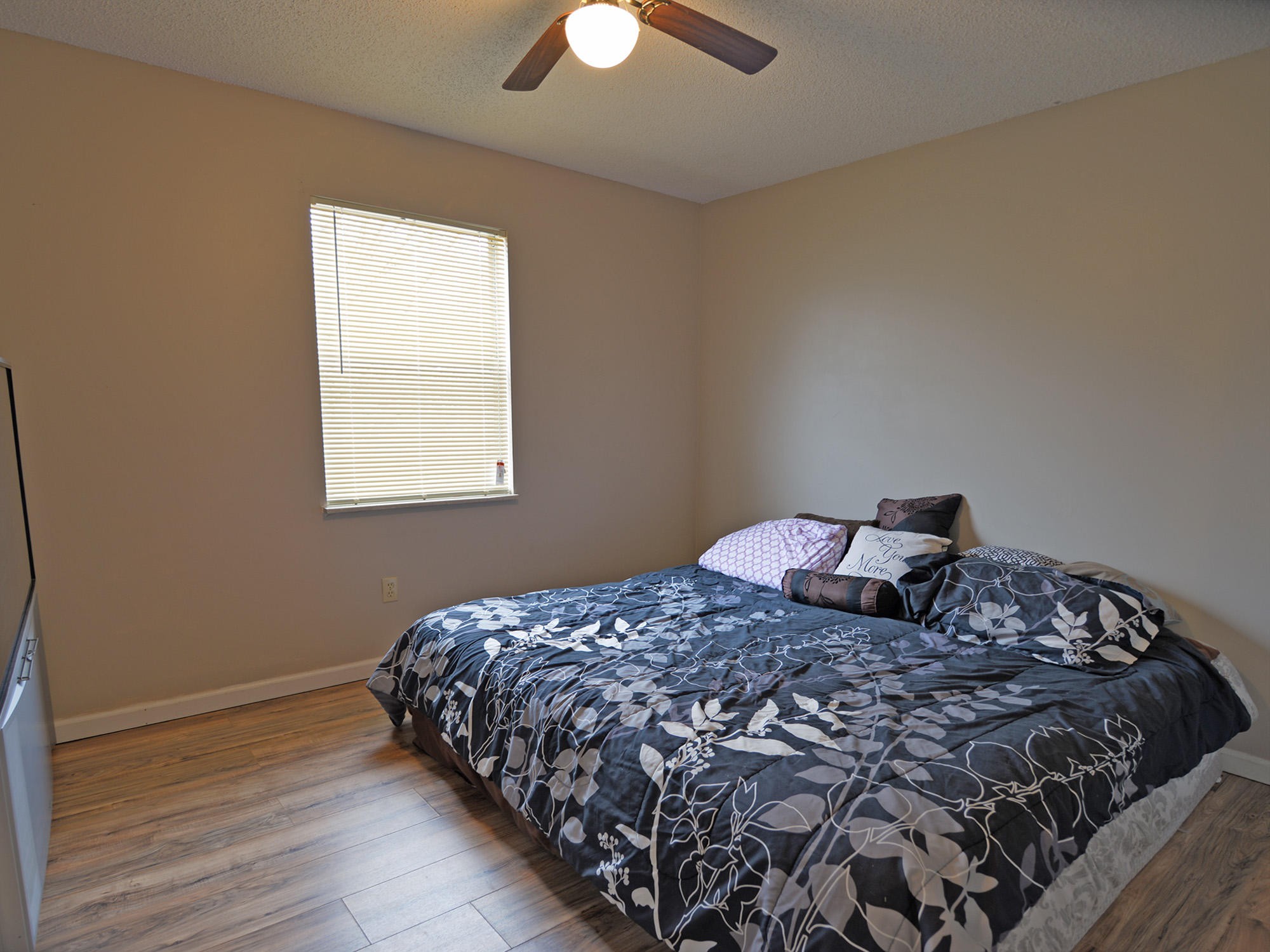 6762 Ross Road Philadelphia, TN 37846 - Photo 8 of 14 a bedroom with a bed and a chandelier