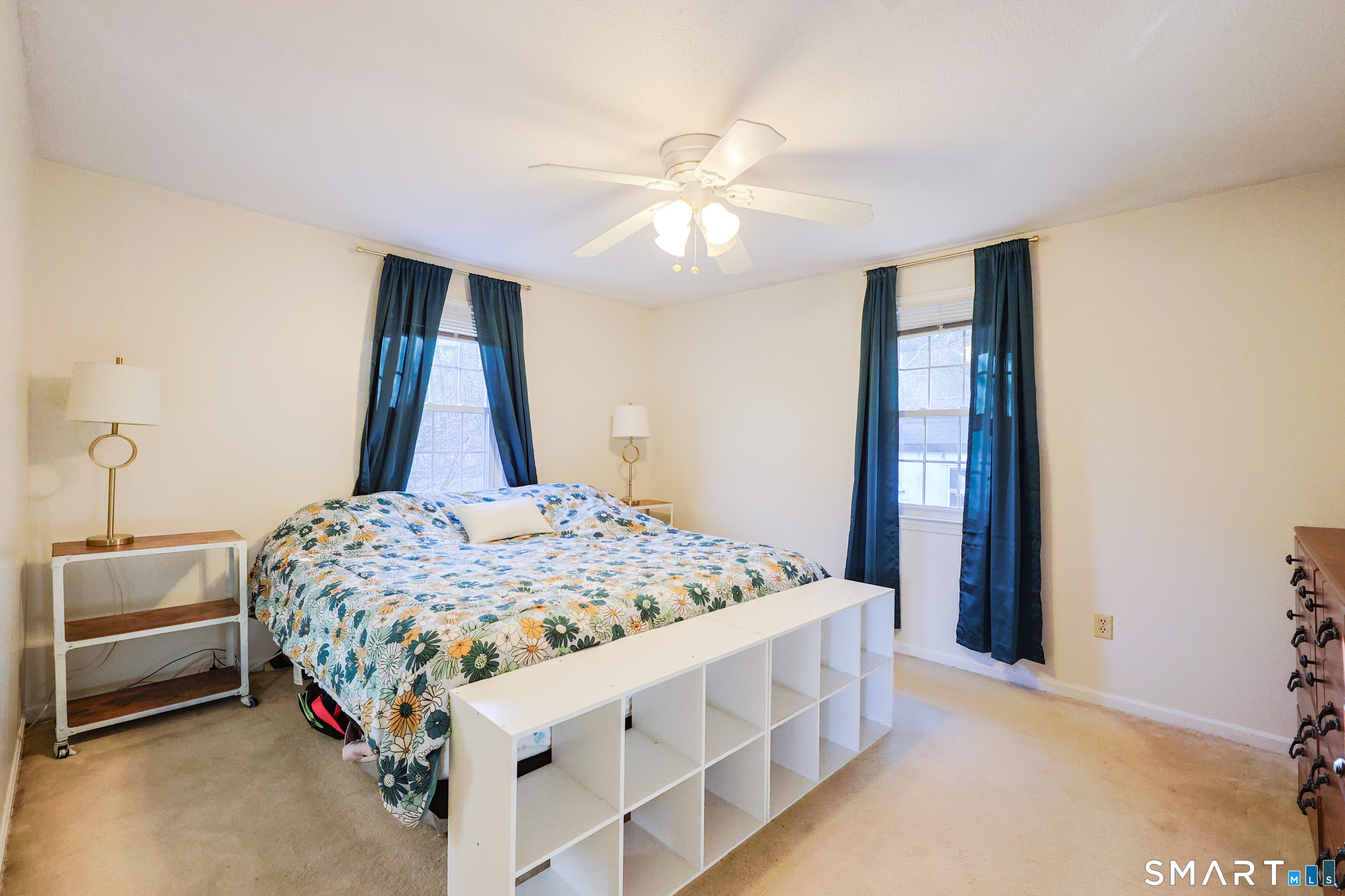 80 Sabin Street Putnam, CT 06260 - Photo 11 of 26 a bedroom with a bed and a chandelier