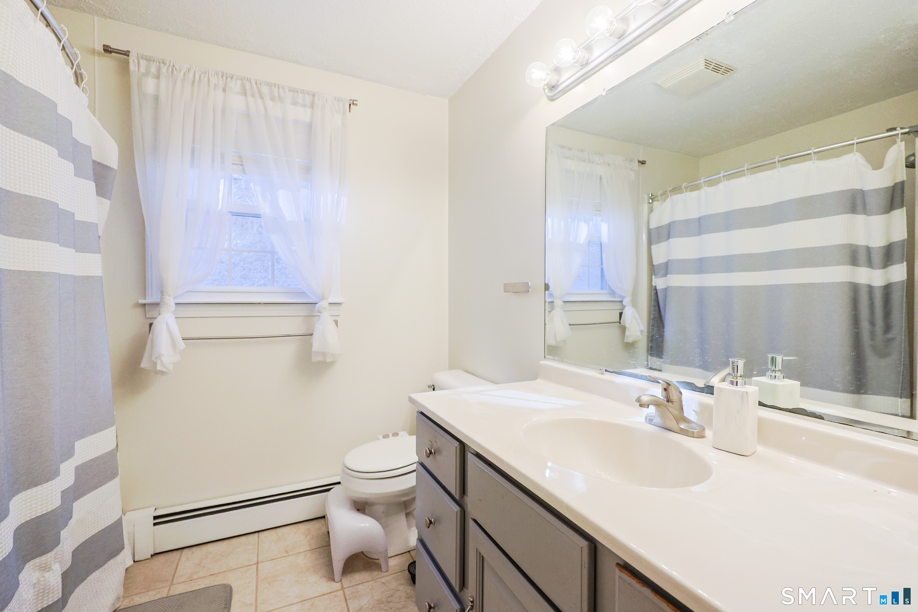 80 Sabin Street Putnam, CT 06260 - Photo 15 of 26 a bathroom with a sink toilet and shower