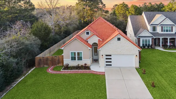a front view of house with yard and green space