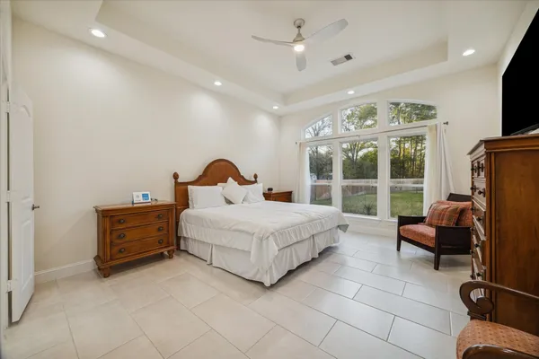 a bedroom with a bed and glass windows