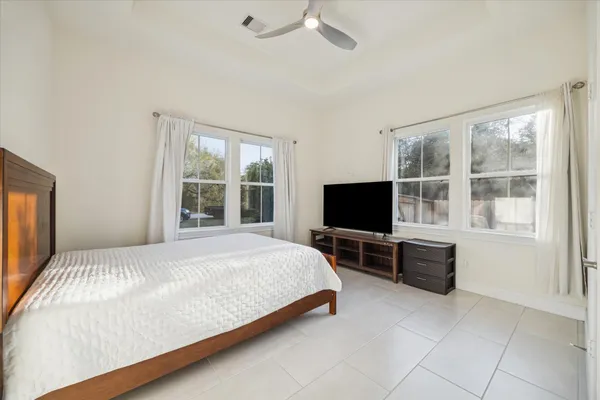 a bedroom with a bed and a flat screen tv
