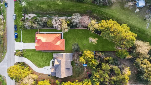 an aerial view of a house with a yard and lake view