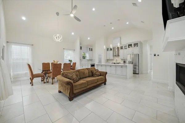 a living room with furniture and a view of kitchen