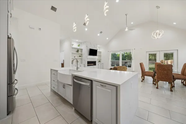 a kitchen with a sink a counter top space and stainless steel appliances
