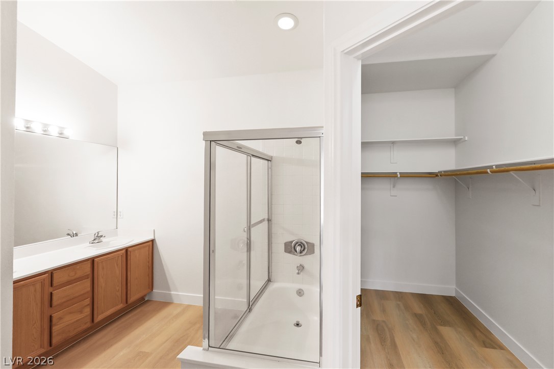 1134 Evening Ridge Street Henderson, NV 89052 - Photo 24 of 35 A well-appointed bathroom suite features a spacious vanity, walk-in shower-tub combination, and a large adjoining closet for optimal organization.
