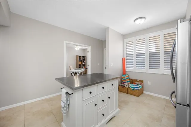 a bathroom with a granite countertop sink and a window