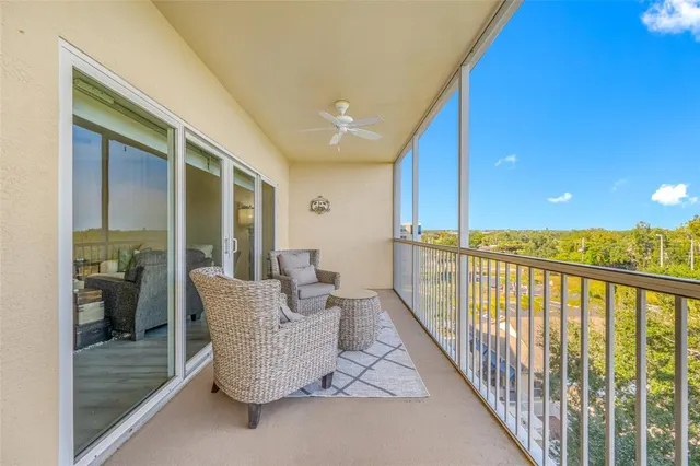 a balcony with furniture and wooden floor