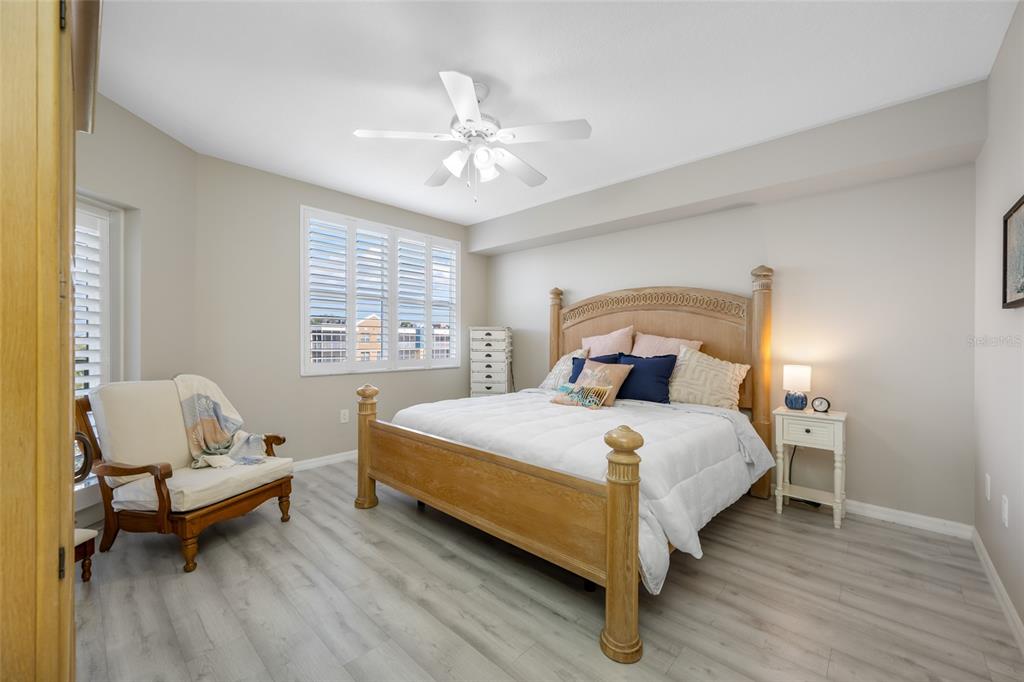 960 Starkey Road, Unit 5504 Largo, FL 33771 - Photo 21 of 46 a bedroom with a bed and a chandelier