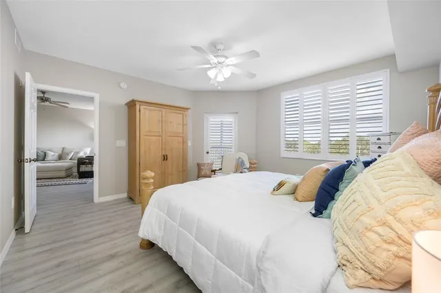a bedroom with a large bed and a chandelier