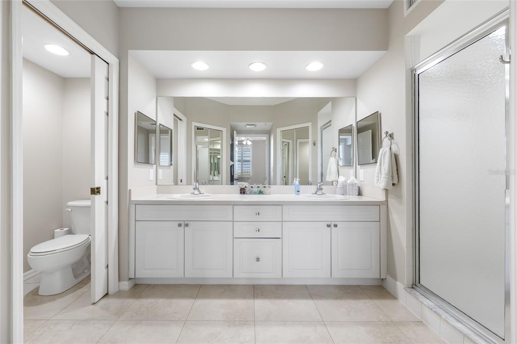 960 Starkey Road, Unit 5504 Largo, FL 33771 - Photo 24 of 46 a spacious bathroom with a granite countertop sink a toilet and a mirror