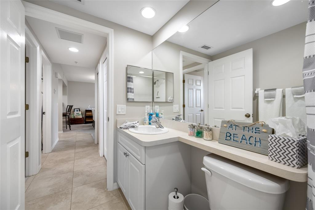 960 Starkey Road, Unit 5504 Largo, FL 33771 - Photo 35 of 46 a bathroom with a sink a toilet and a mirror